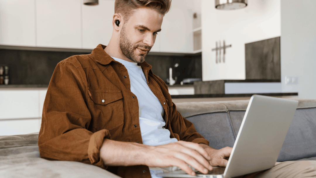 Man sitting on the couch on his laptop