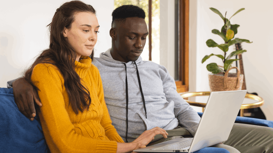 couple sitting together on a laptop