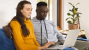 couple sitting together on a laptop