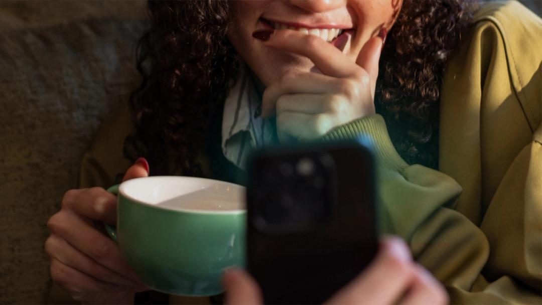 Woman smiling at her phone