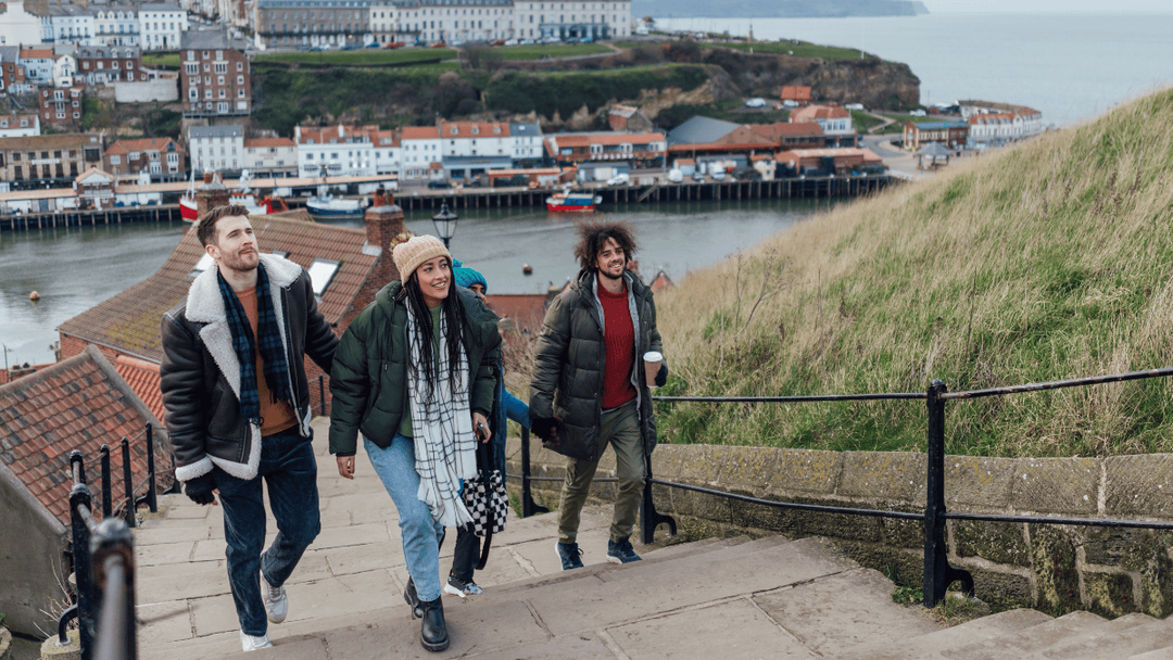 coastal english town friends climbing stairs