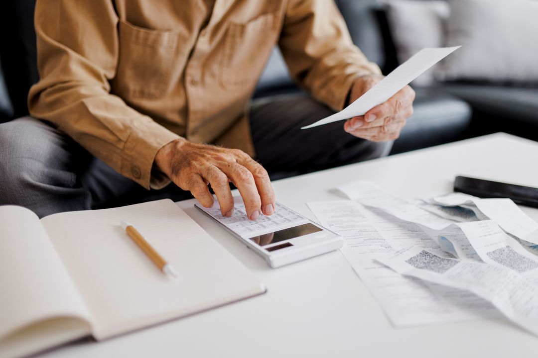 Man working out bills with a calculator
