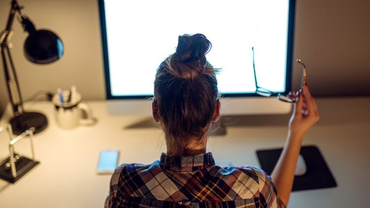 Young businesswoman working on computer indoors, occupation technology.