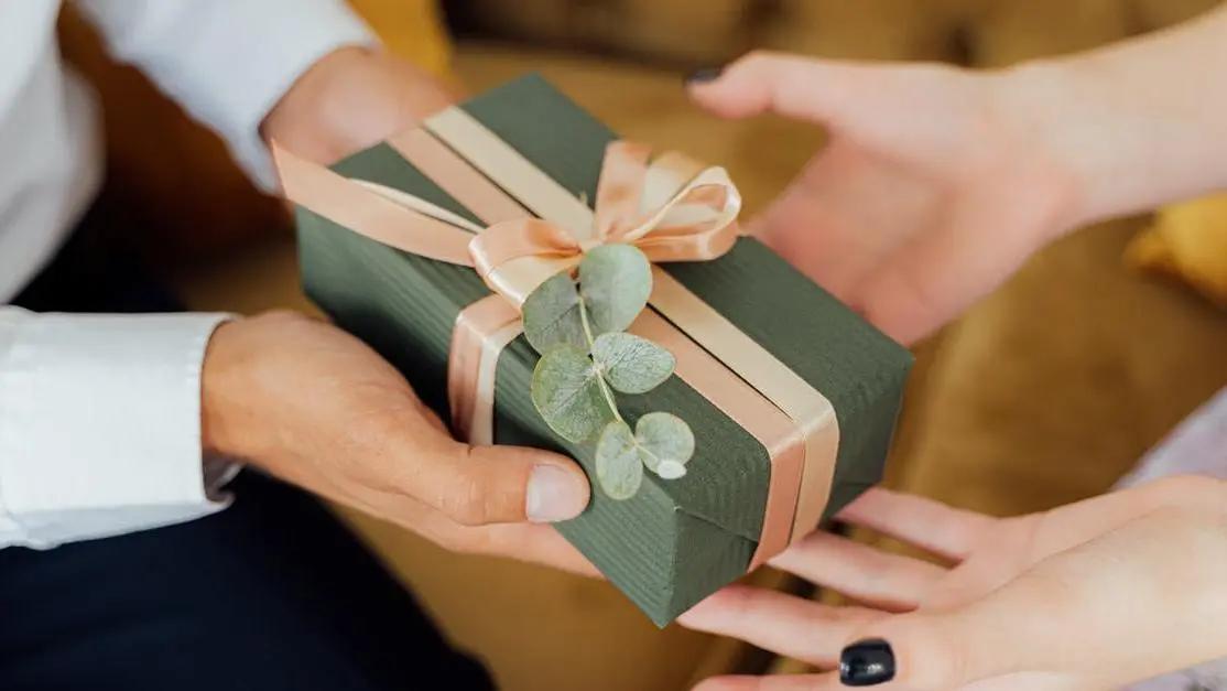 Hands exchanging a beautifully wrapped gift, illustrating why thoughtful gifts matter.