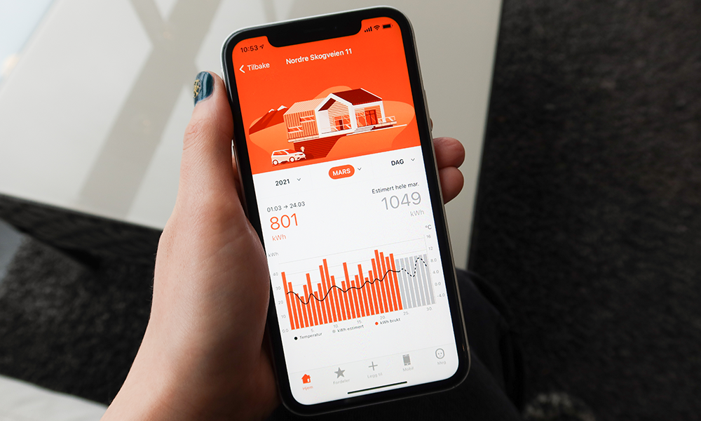 En hånd som holder en telefon med Fjordkraft-appen åpen