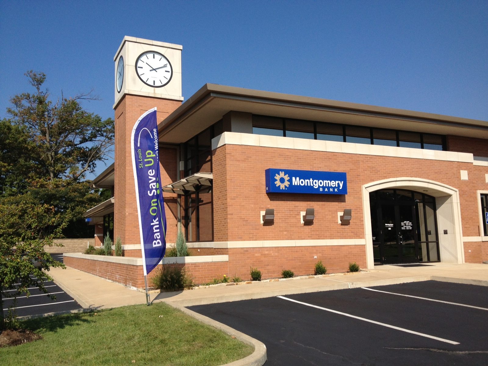 Bank branch exterior with a Bank On Save Up promotional flag