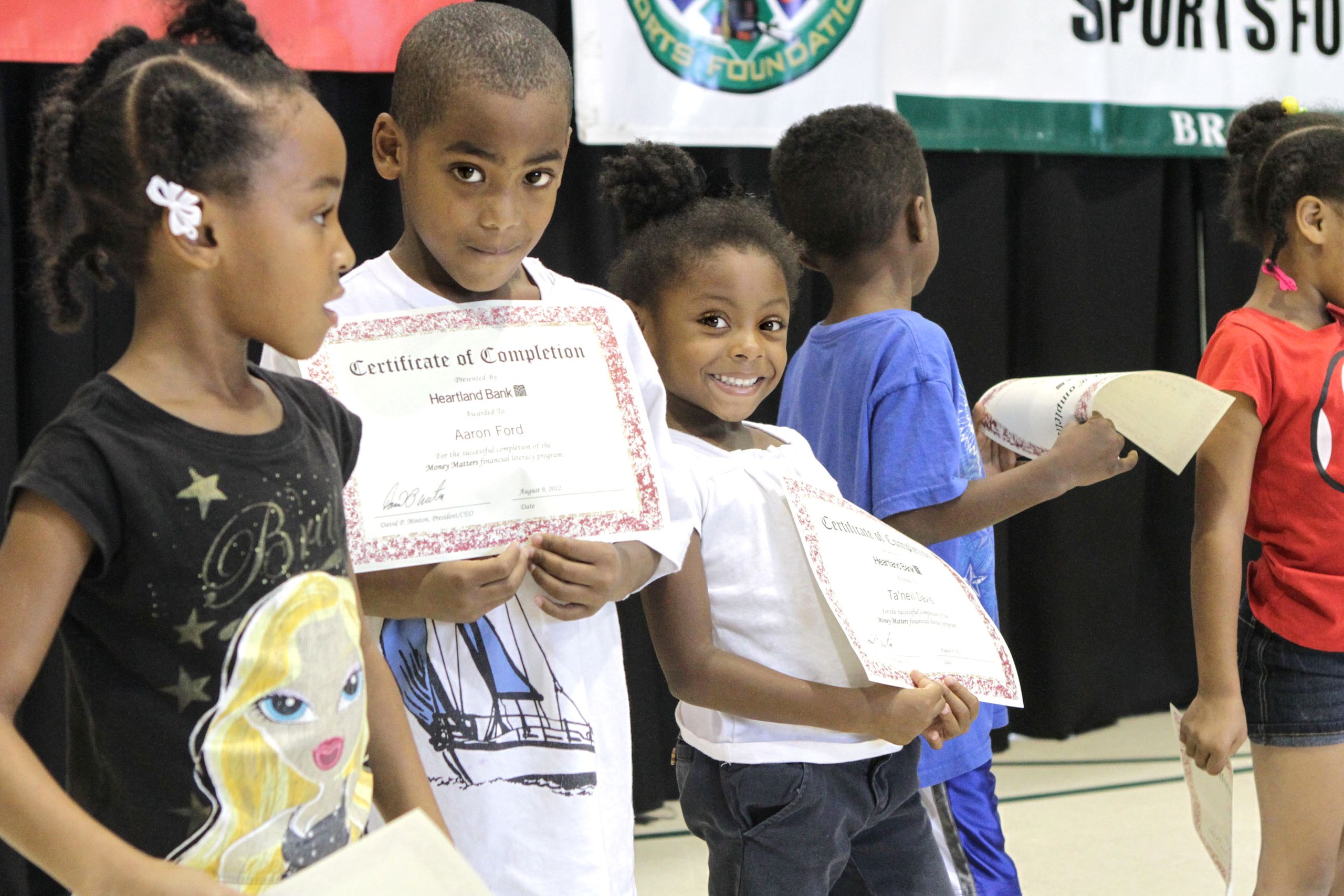 Children holding certificates during a group event