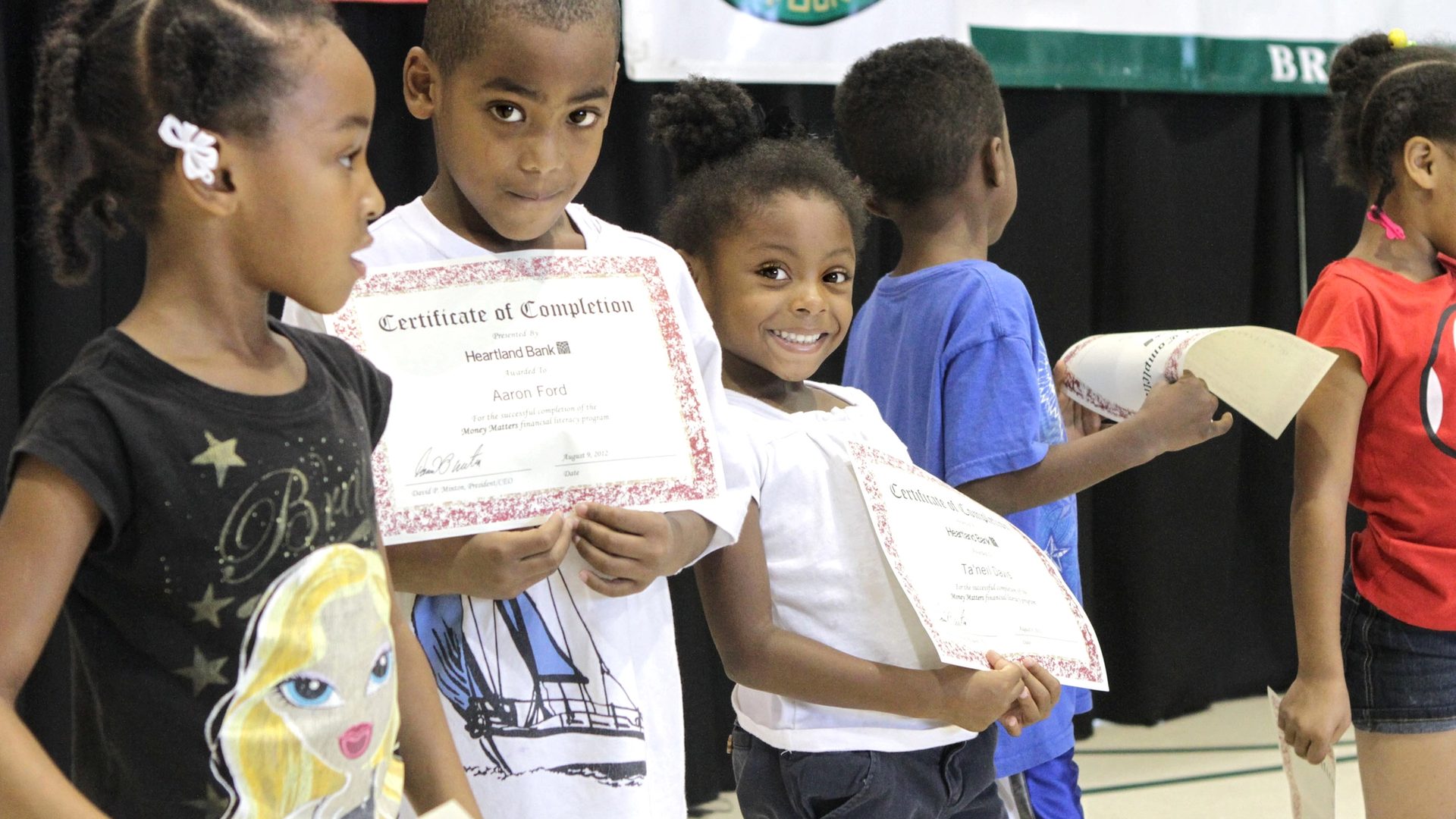 Children holding certificates during a group event