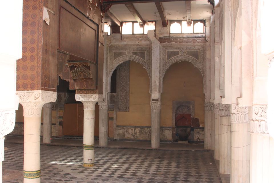 Collapsed prayer hall, its pillars and arches still standing beneath the open sky