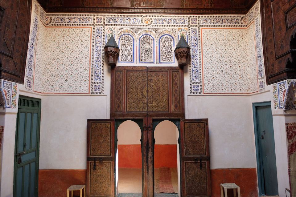 Salon of the Douiria de Mouassine: carved stucco, painted wooden ceiling, double-leaf doors