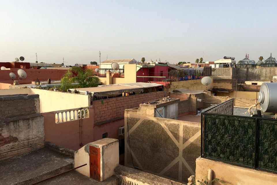 Marrakech roof terraces in the early morning, wrought-iron railings and ochre walls