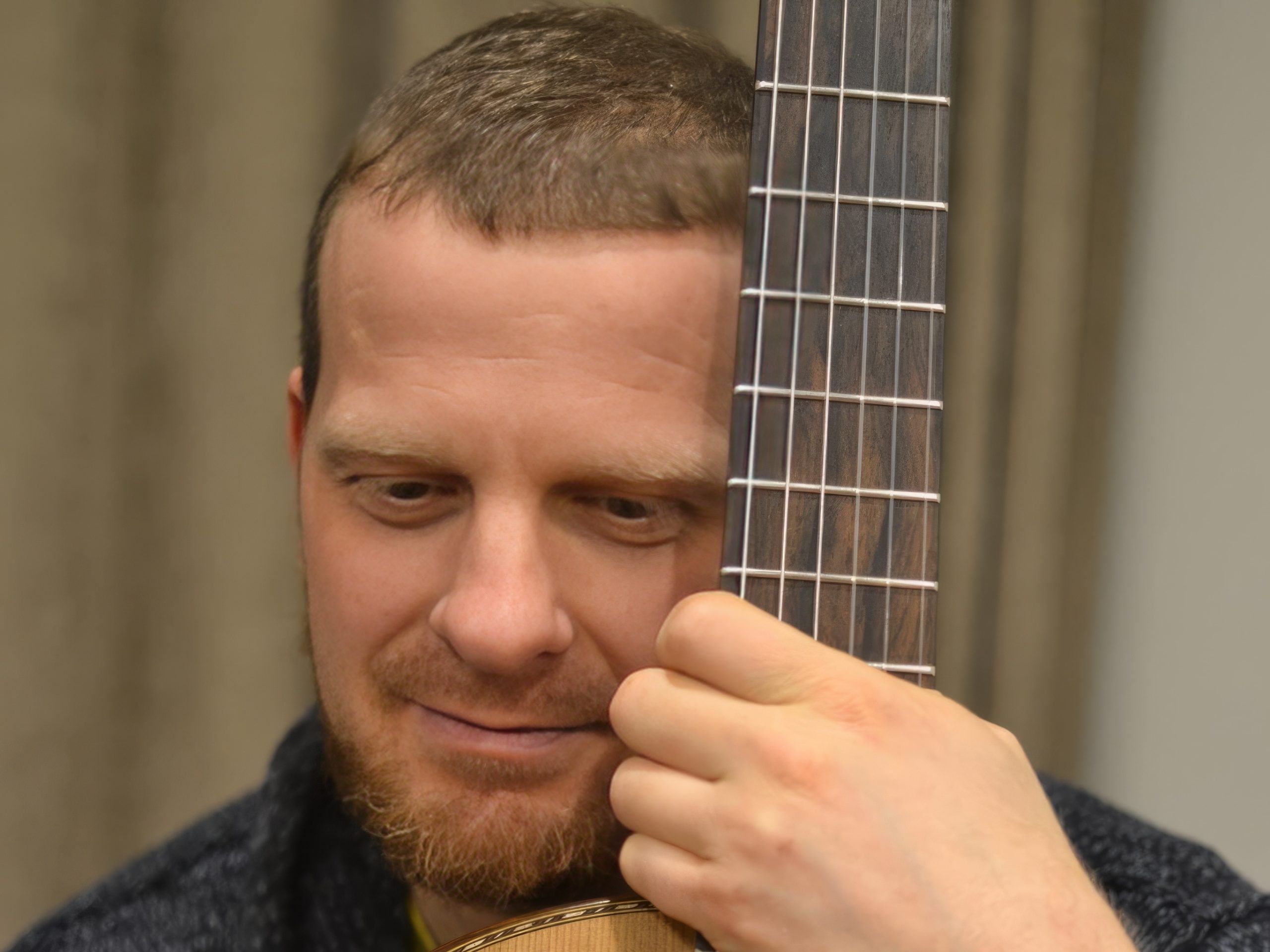 Maksim Cuker holding one of his guitars.