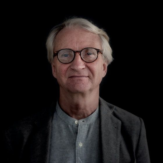 Erik Stenstadvold in front of a black background looking at the reader.