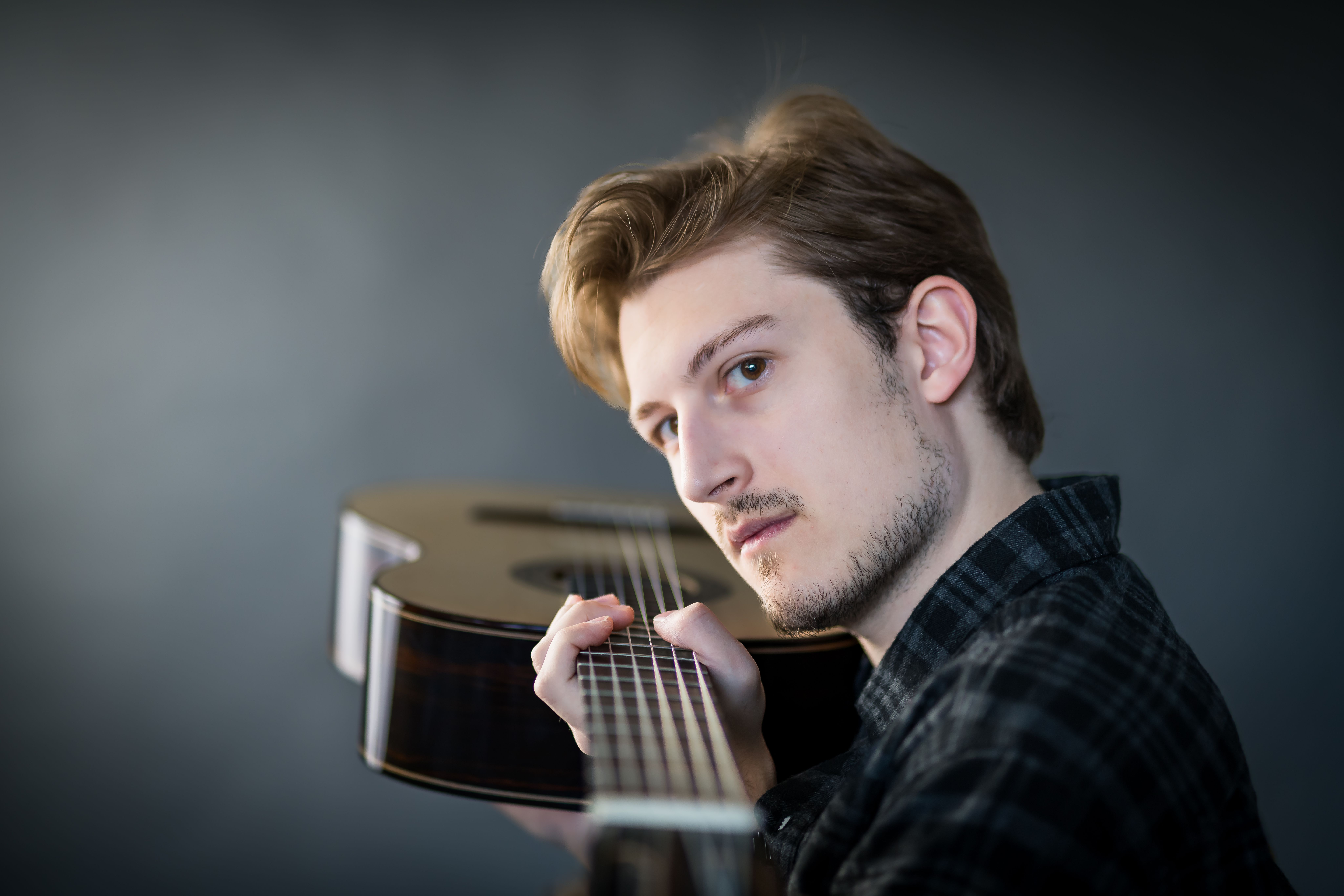 Dylan pointing his guitar at the camera