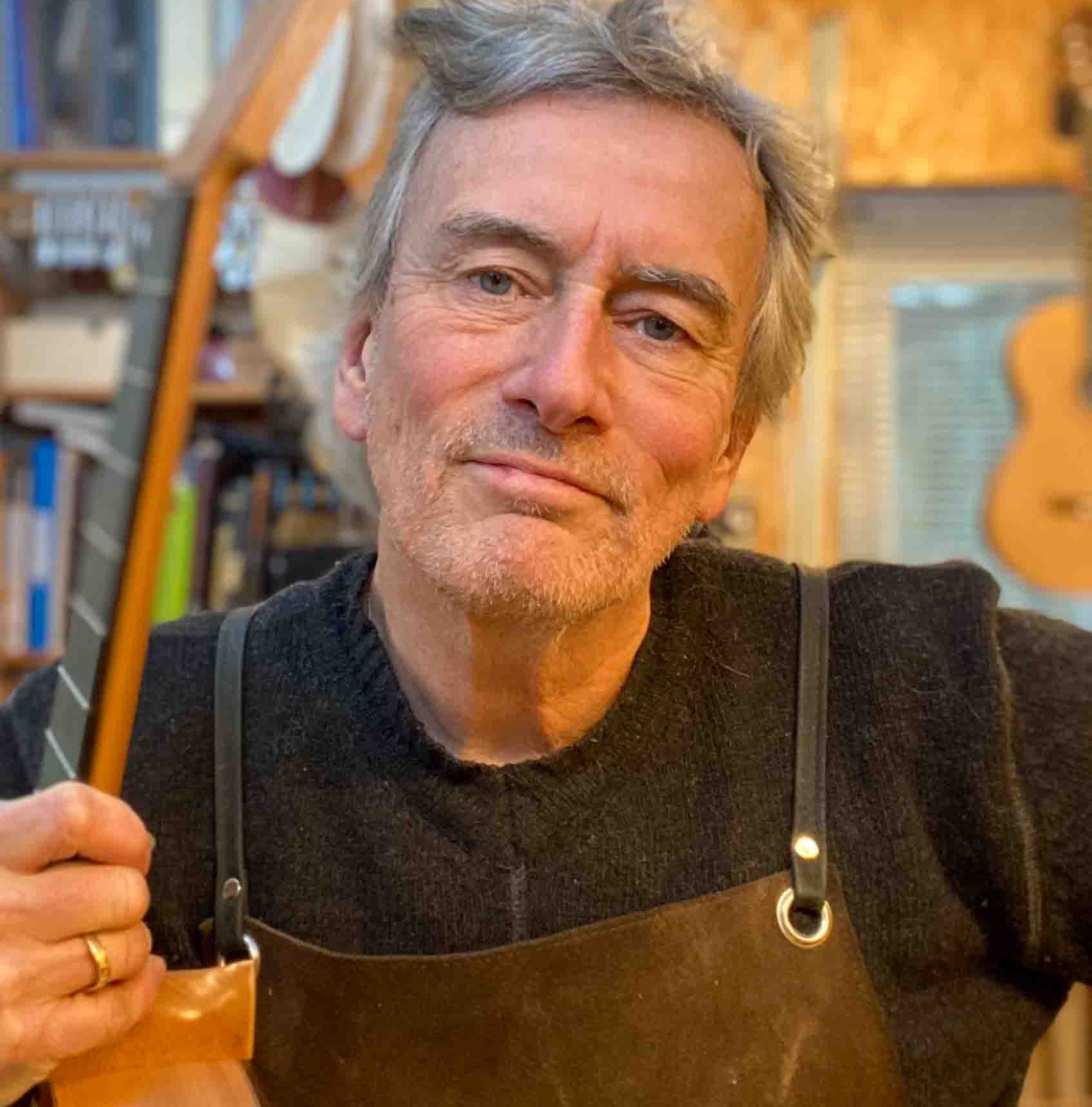 Albert Cox holding one of his newly build guitars.