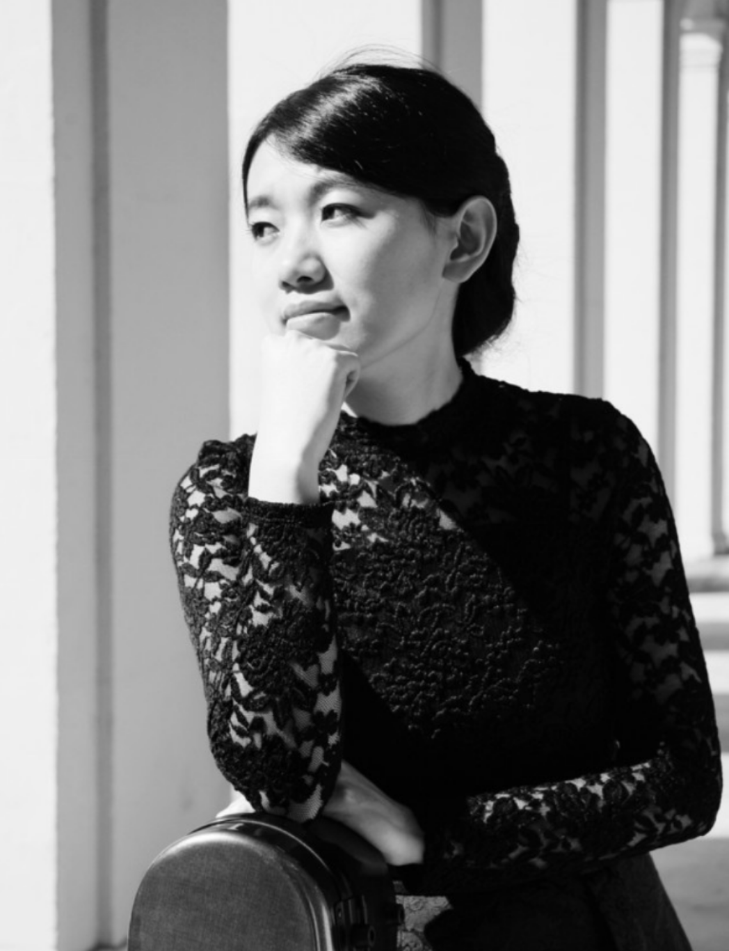 Black and white image of Lying looking thoughtful while staring into the distance