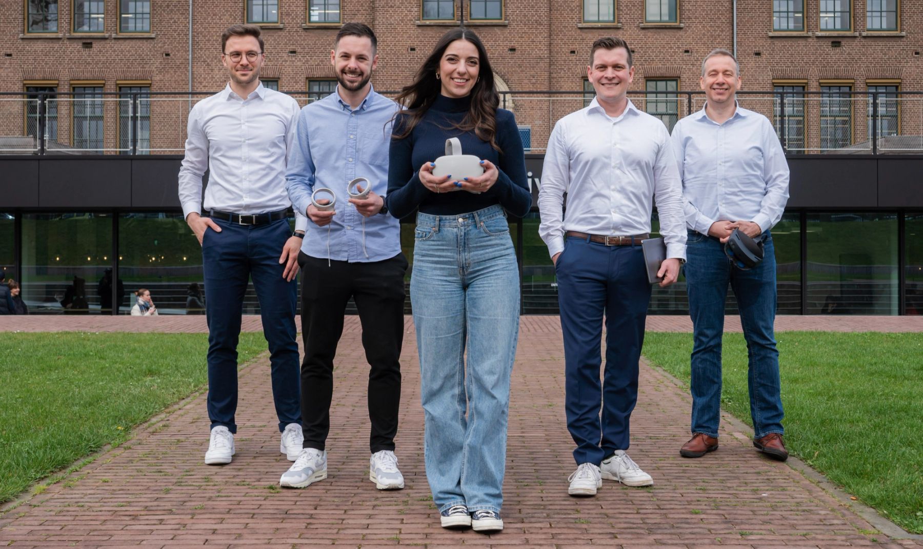 The DEXLab team holding VR headsets