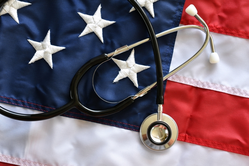 Image Stethoscope placed over American flag representing birth injury claims at military hospitals and federally funded clinics under federal law