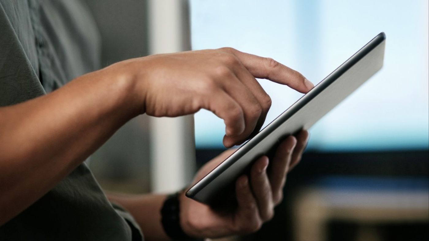A hand navigating a case dashboard on a tablet