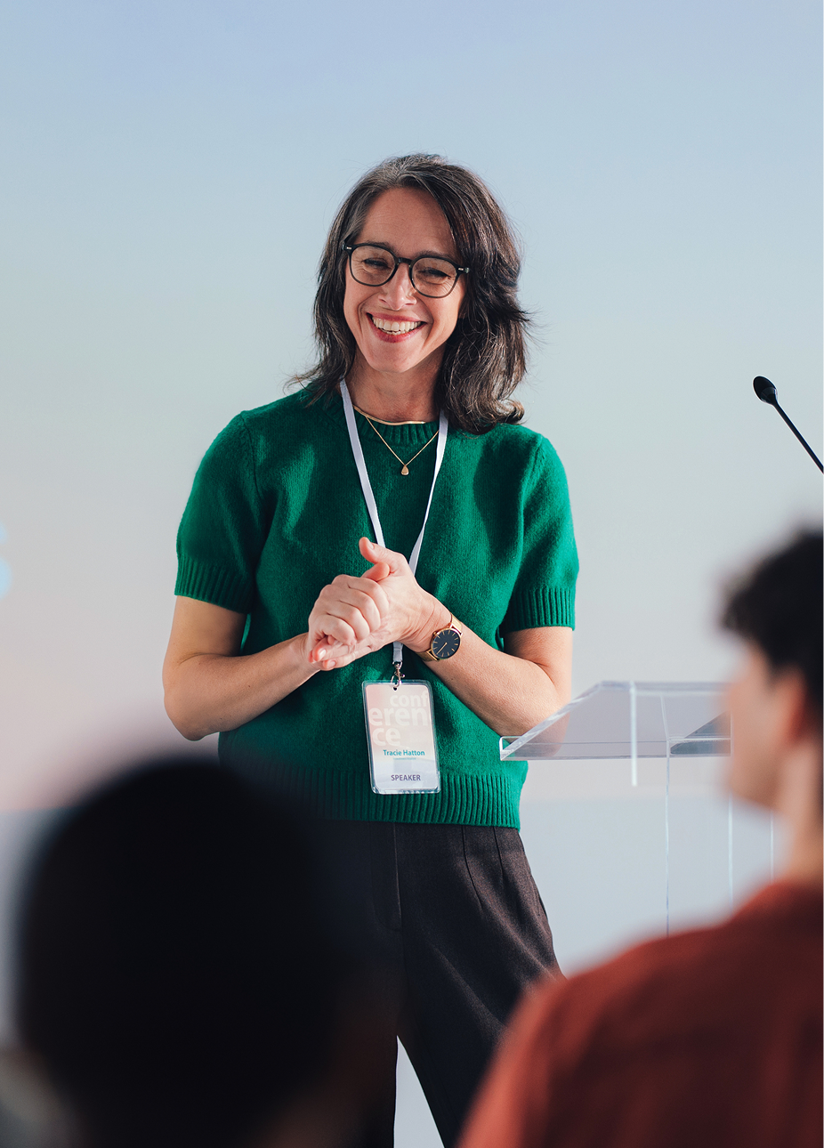 A founder speaking at a conference lectern