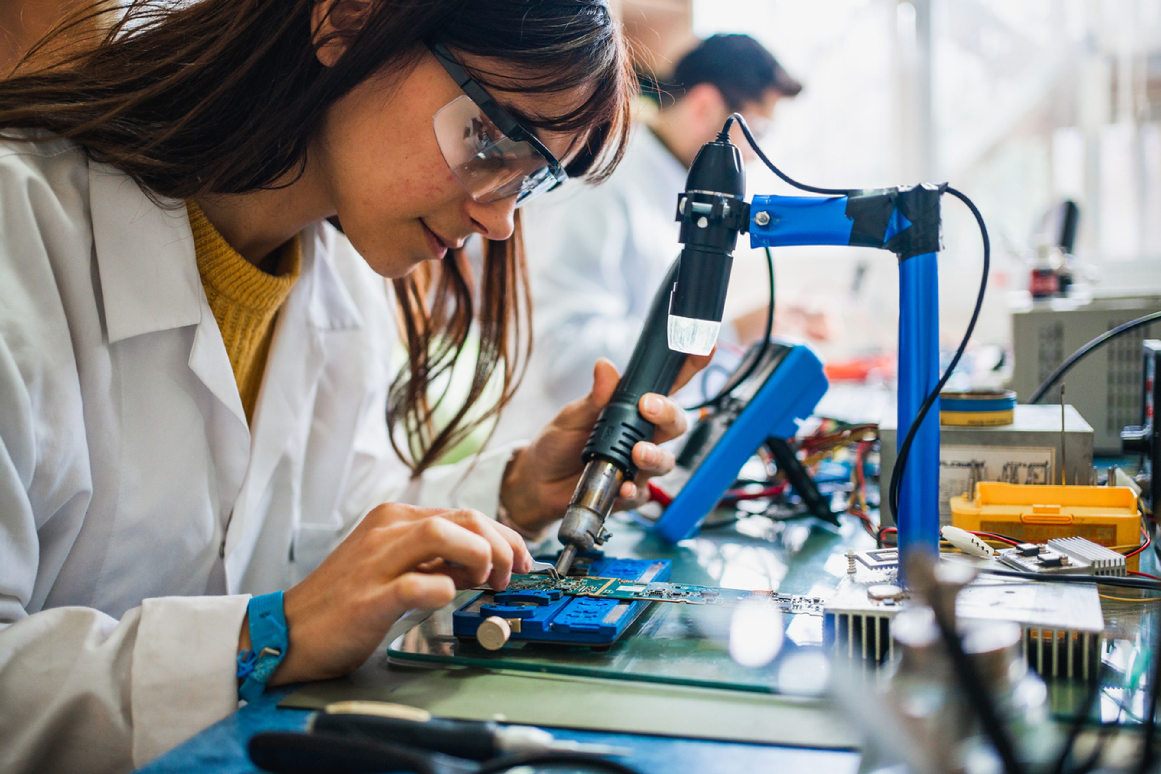 Student in a lab learning how to build robotics
