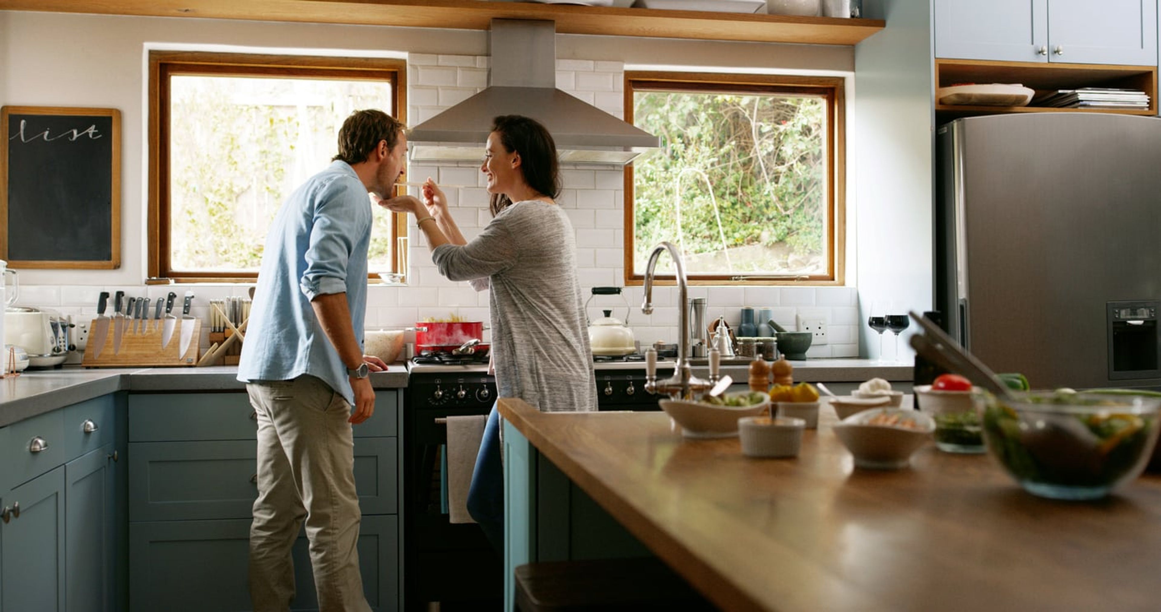 Happy couple cooking together in their kitchen.