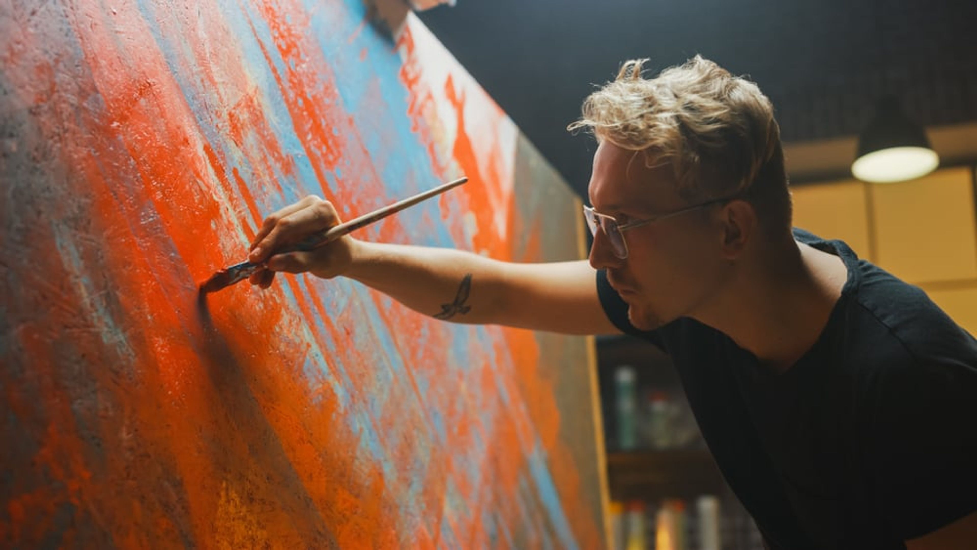 Portrait of an artist painting in his studio.