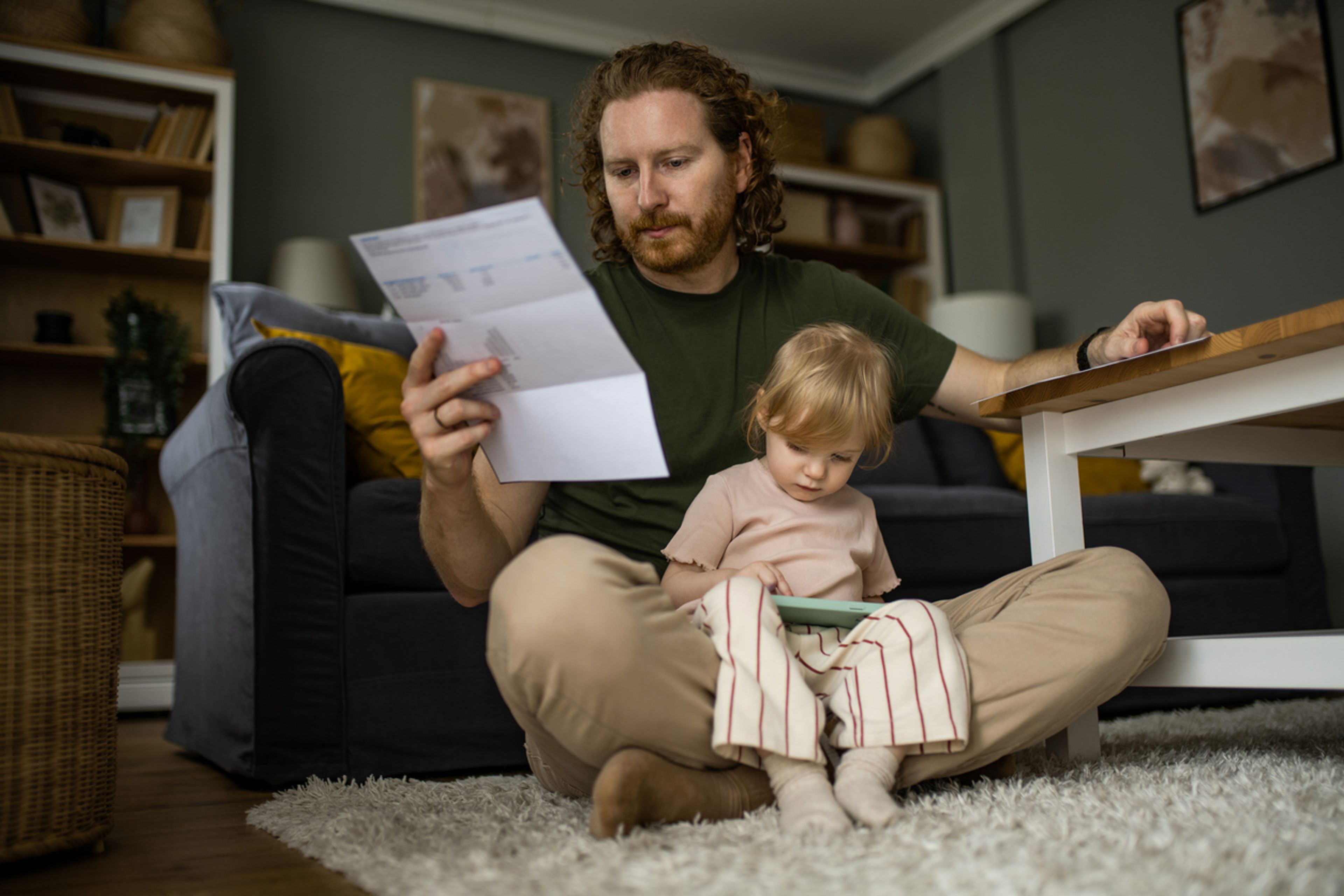 Concerned father looking over expenses with his young daughter.