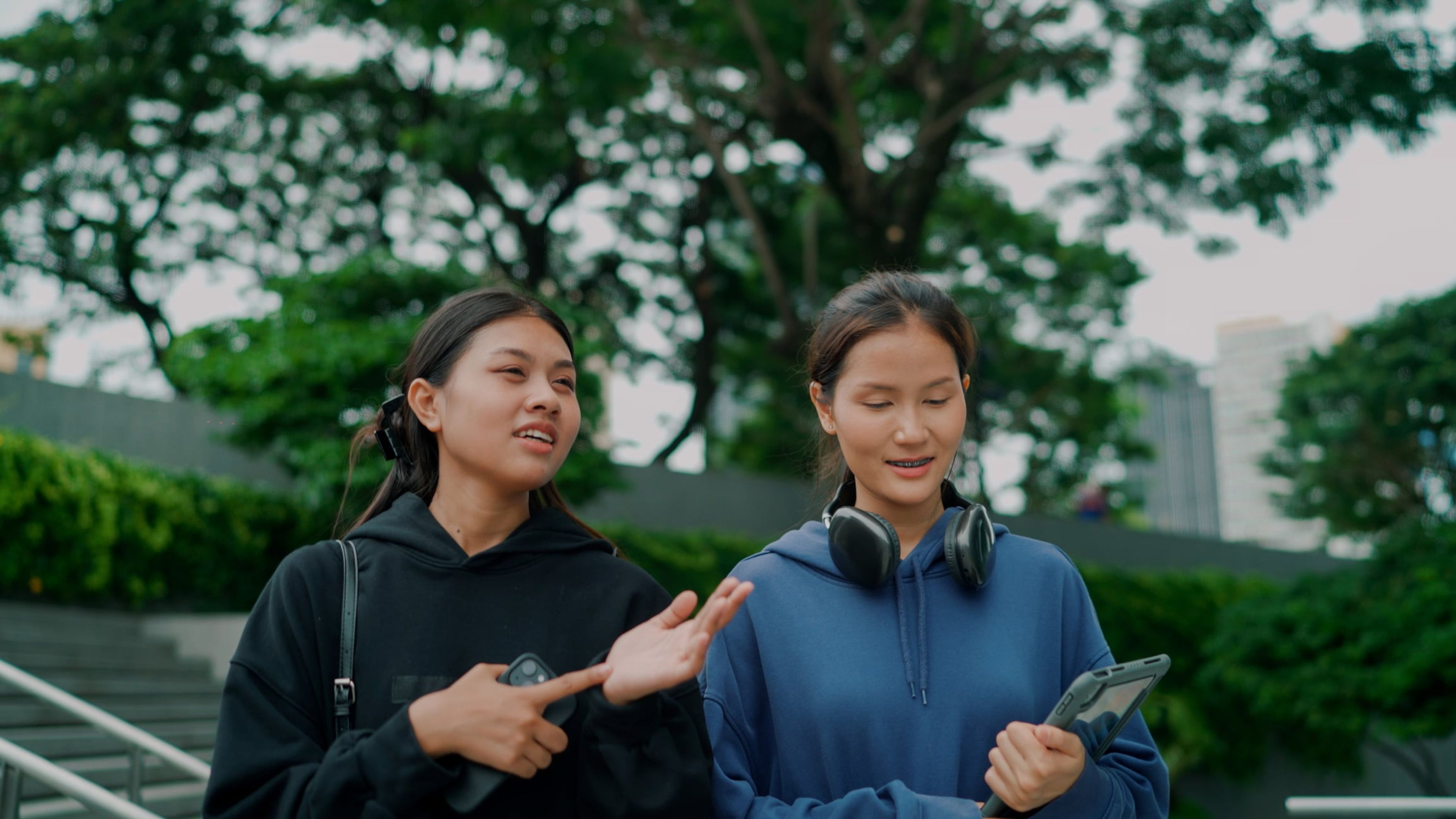 Two young women are walking and having a conversation about their OPT options on an F-1 visa.