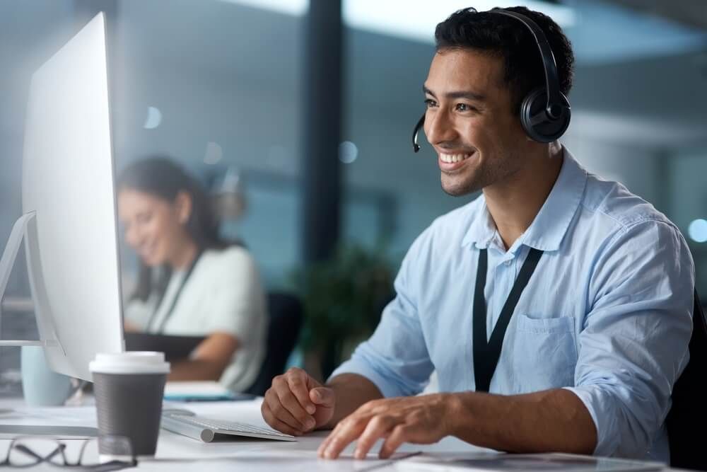 Man on laptop in call center