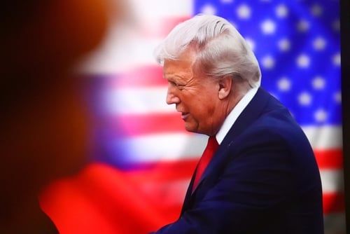 President Trump at a podium announcing the $100K H-1B fee proclamation