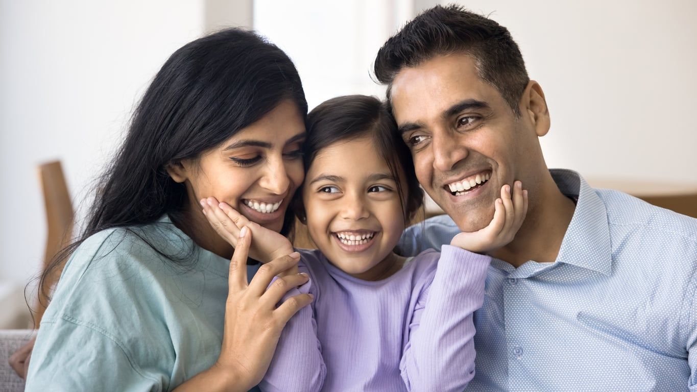 Closeup of a happy child between her father and mother