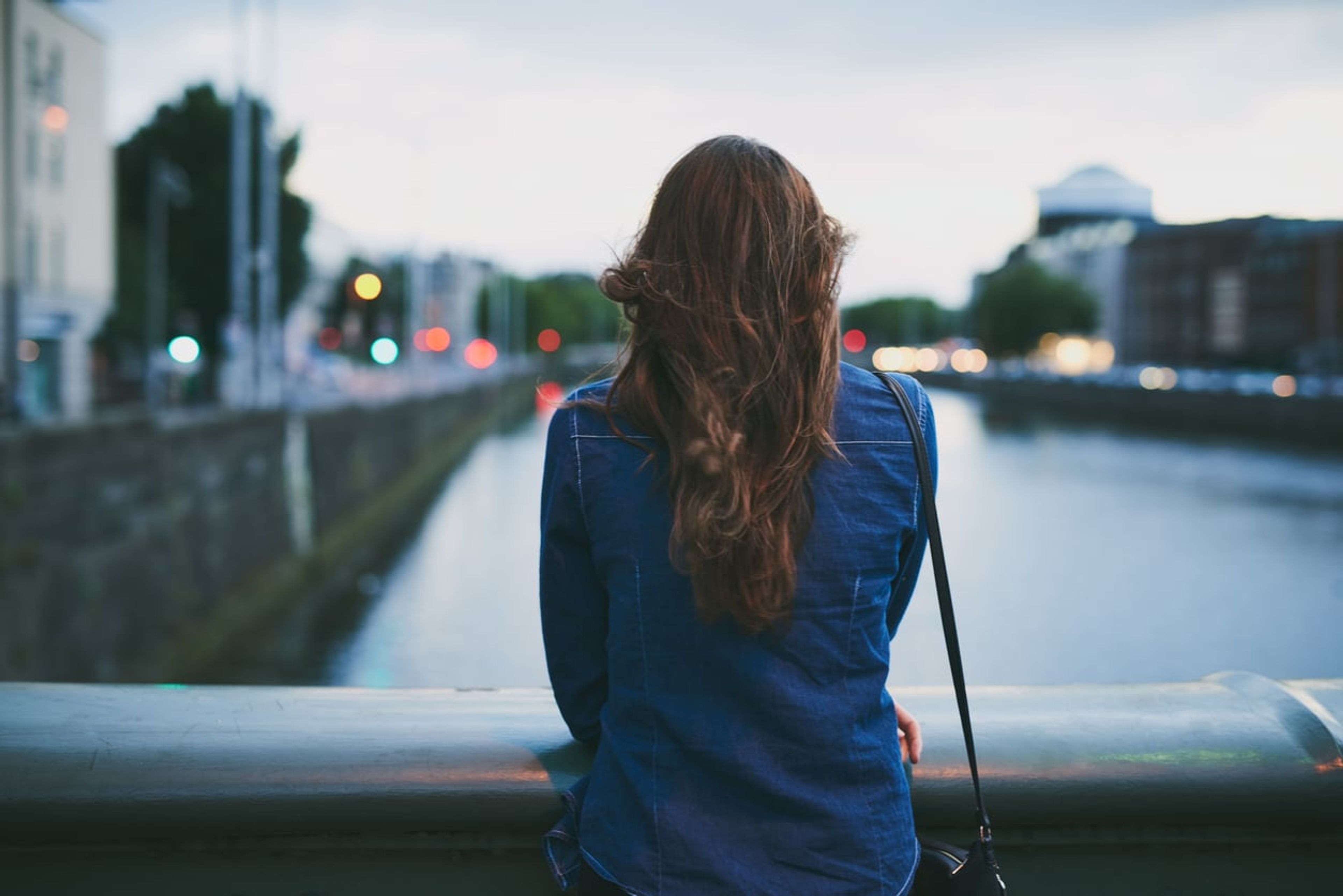 Rearview shot of a woman looking off into the distance.