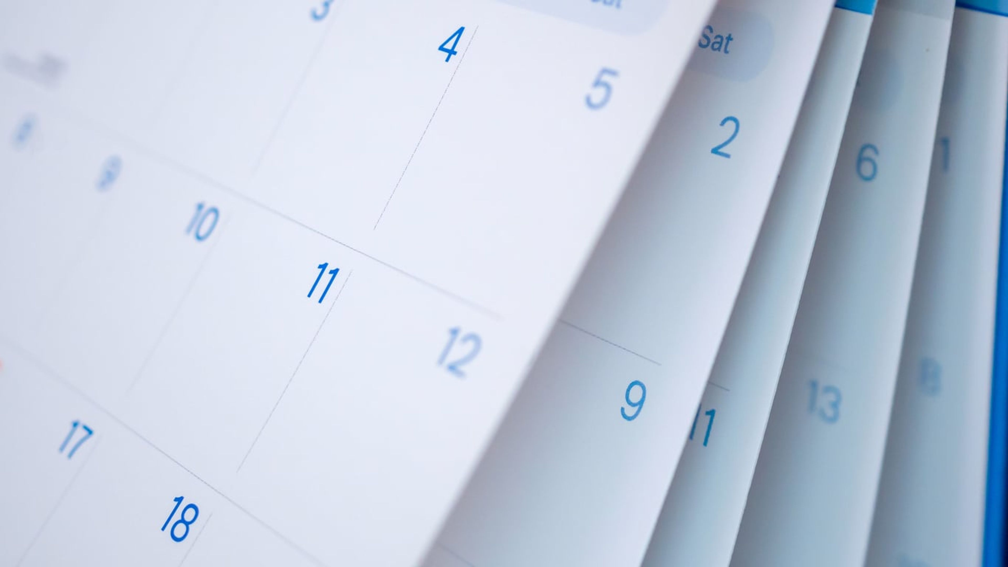 A closeup of calendar pages flipping