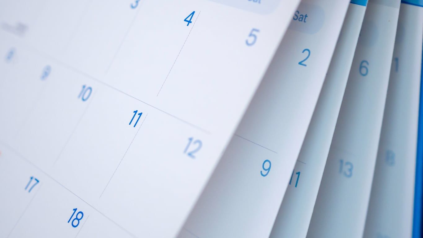 A closeup of calendar pages flipping