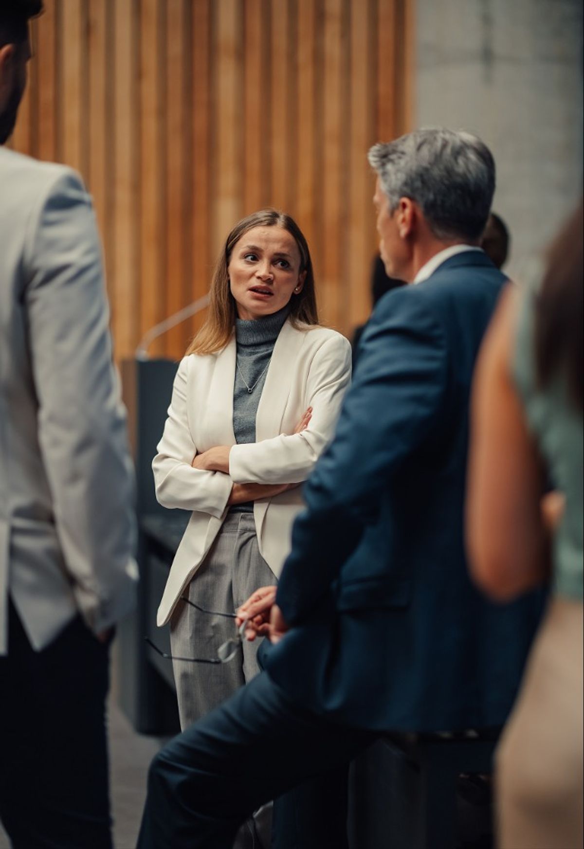 A professional in conversation with colleagues at an industry event