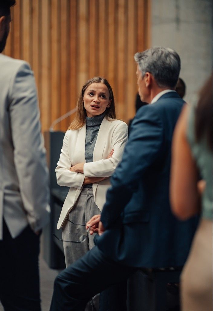 A professional in conversation with colleagues at an industry event