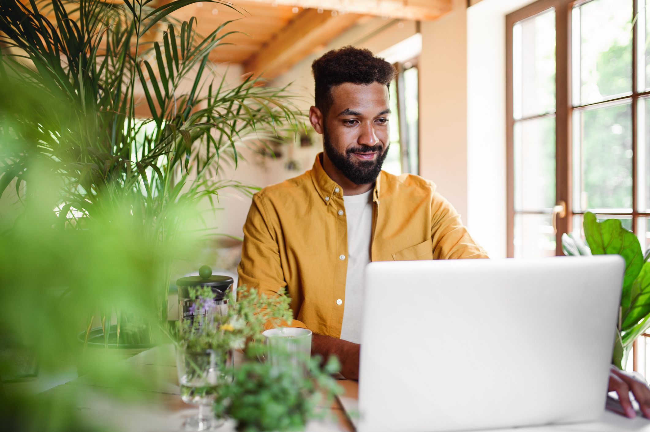 person with laptop and coffee works in office