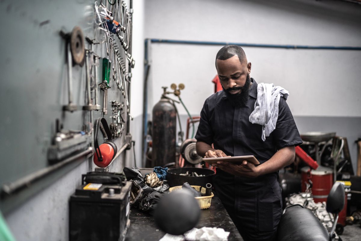 Man working with tablet in auto repair