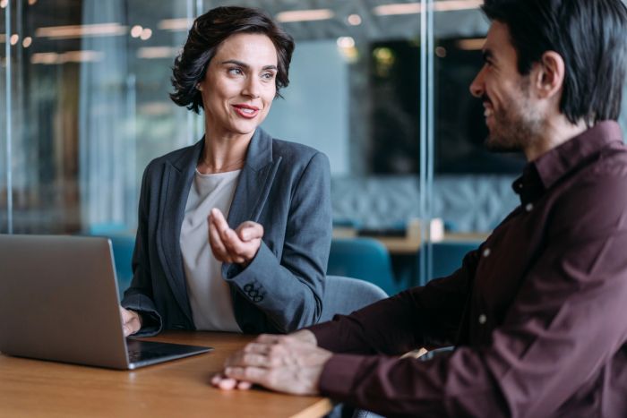 Startup founder having a discussion with her business partner at the office.
