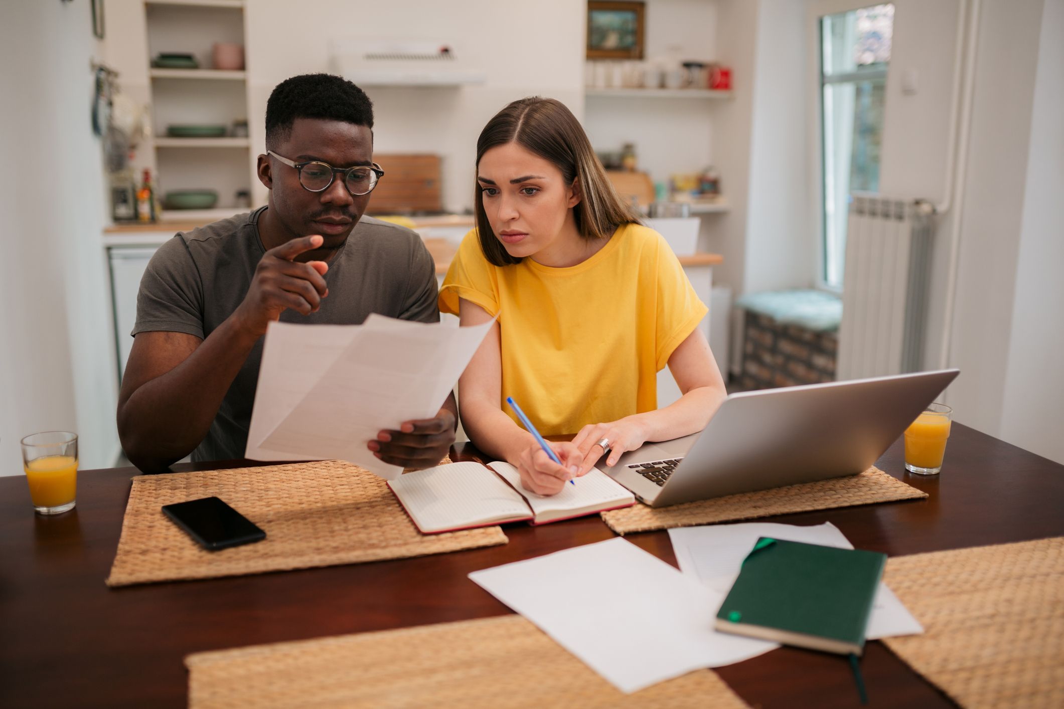 couple sitting at table working at paperwork