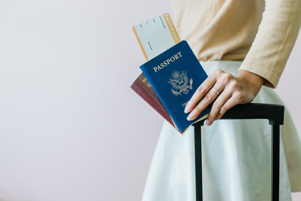 Traveler at the airport holding an I-512 advance parole document