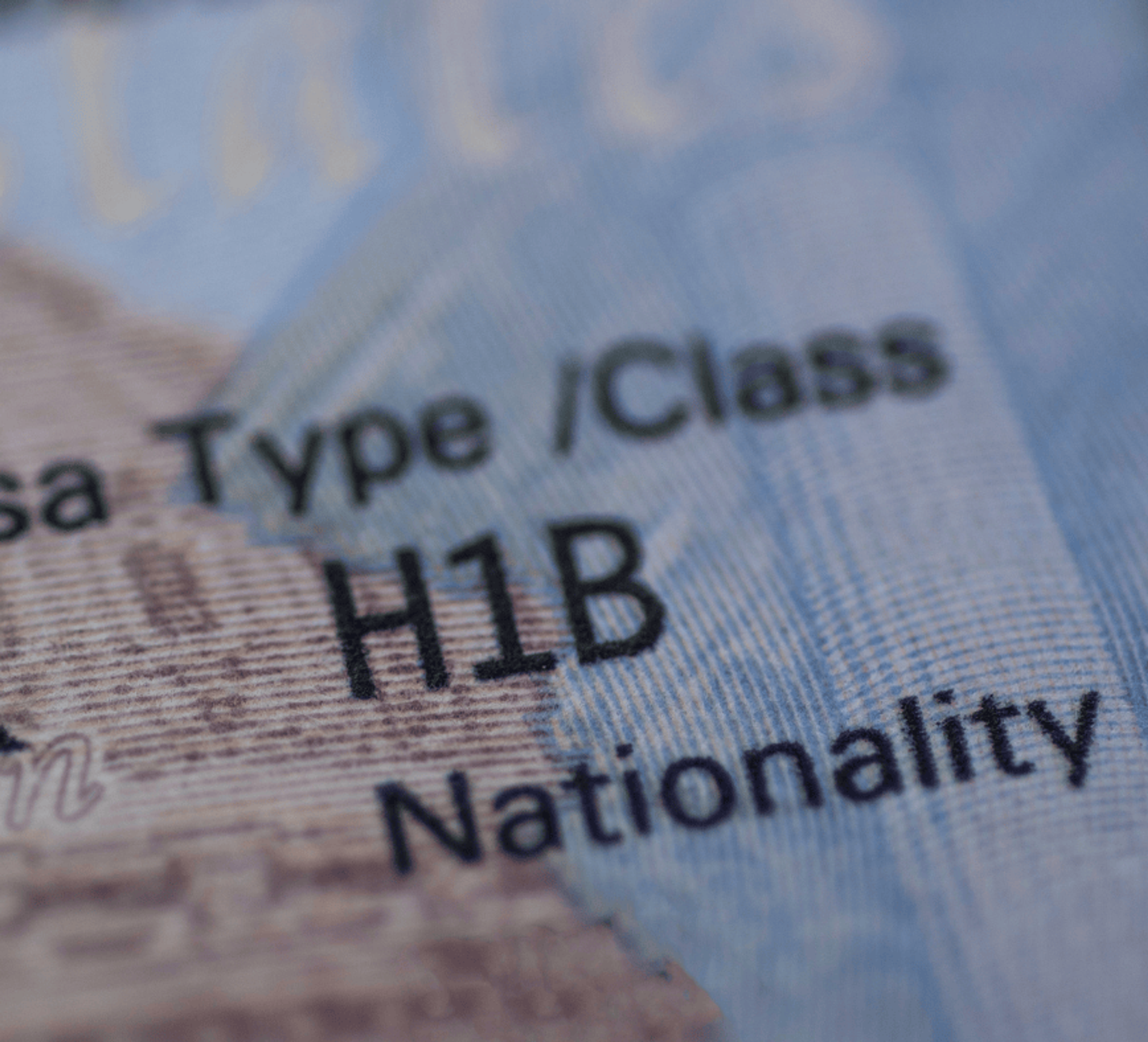 H-1B employee reviewing visa extension paperwork with an attorney