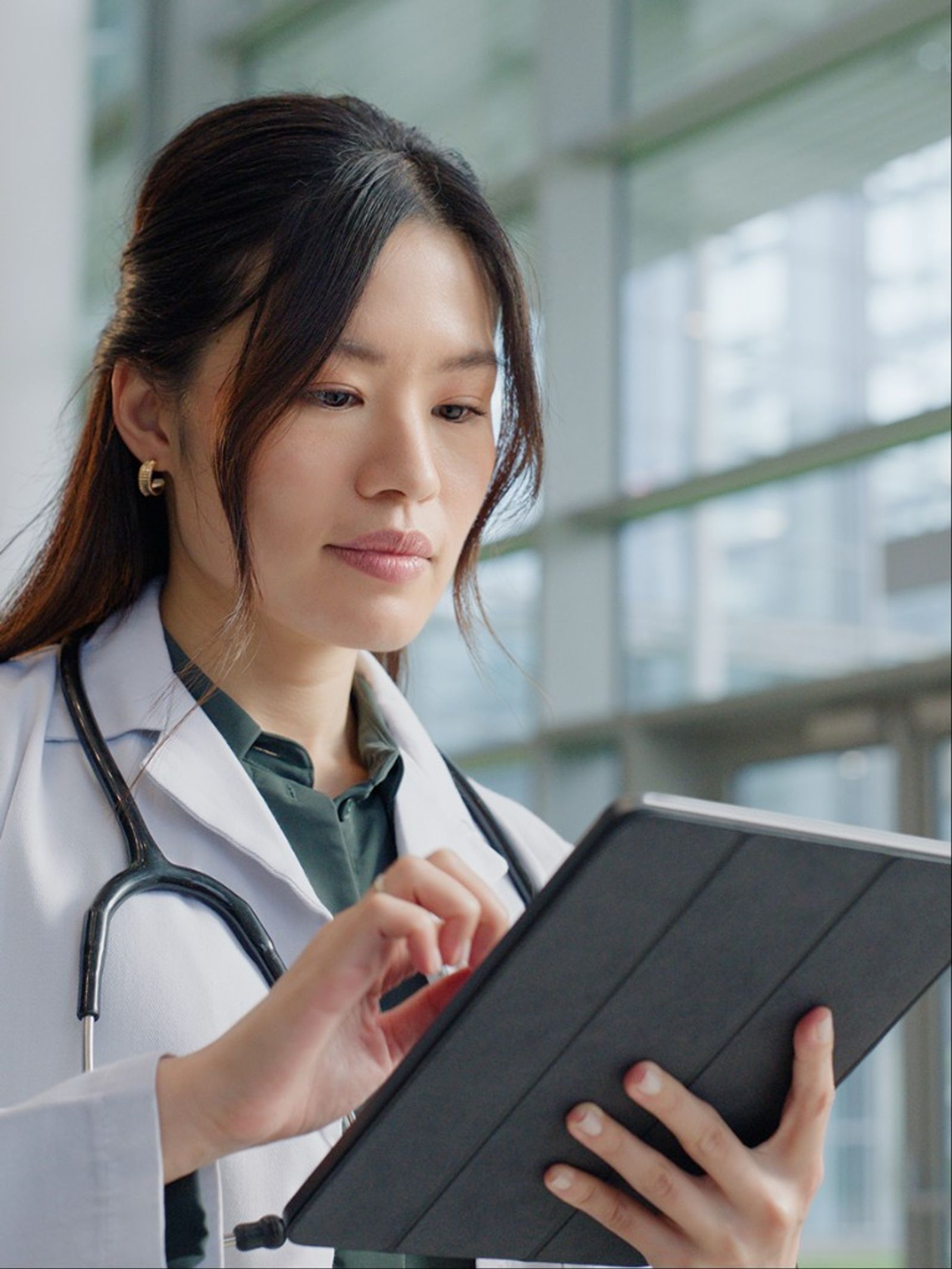 A physician reviewing information on a tablet