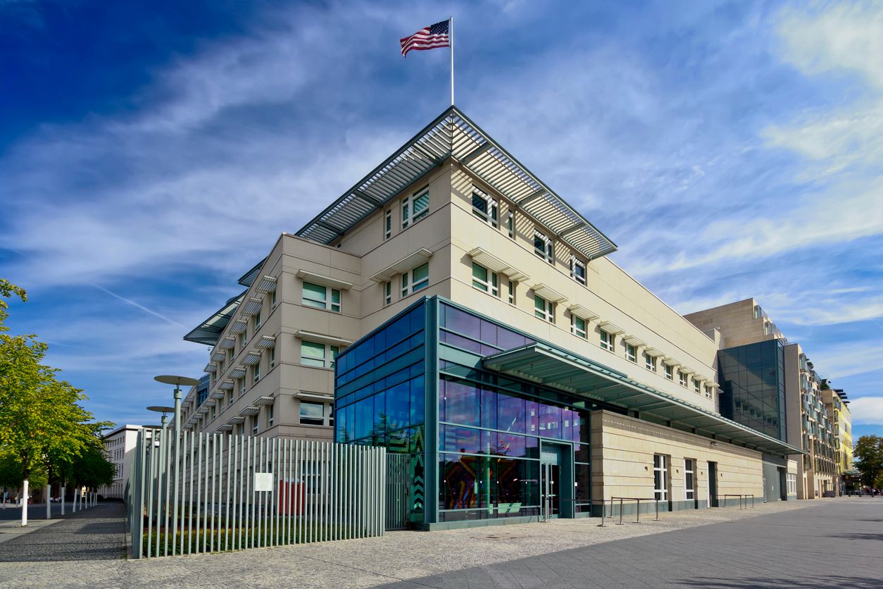 Traveler at a U.S. consulate counter booking an expedited visa appointment