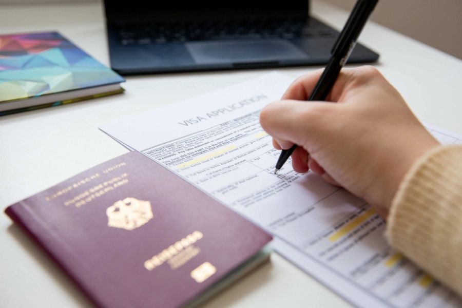 Traveler holding a passport affected by the B-1/B-2 tourist visa bond program