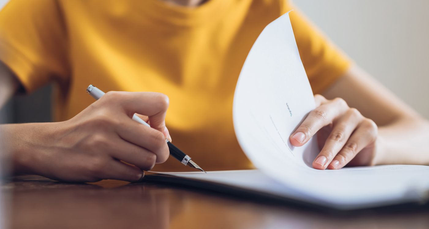 Woman filling out an asylum work permit application form