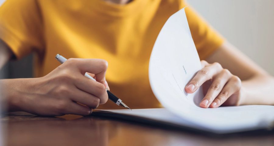 Woman filling out an asylum work permit application form