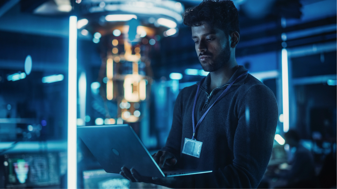 An engineer reviewing a laptop in a high-tech lab