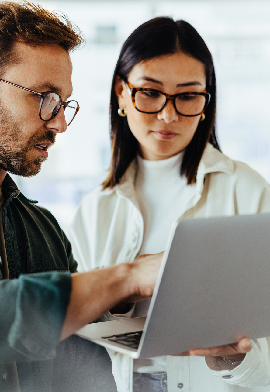 Two startup founders reviewing work together on a laptop